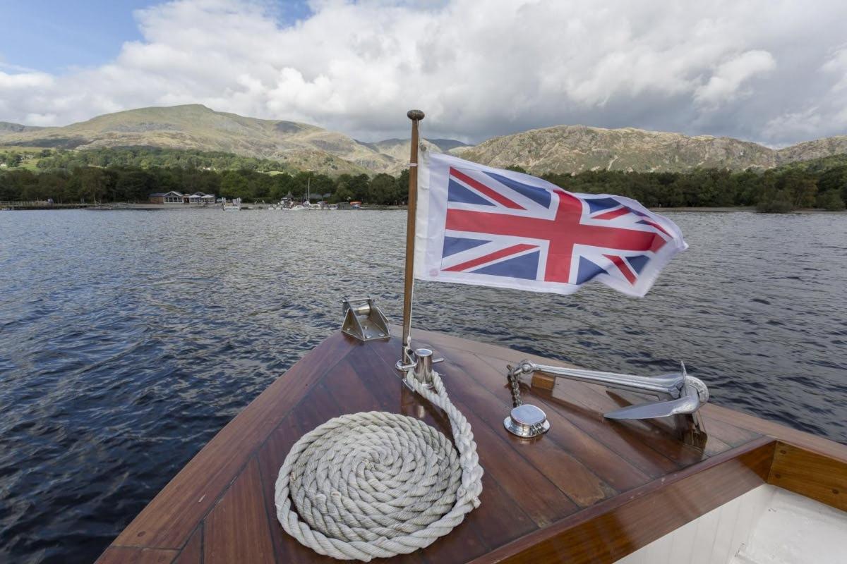 a boat with a british flag on the water