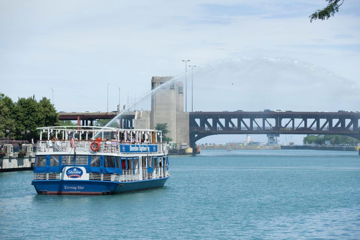 a boat on the water with a bridge in the background