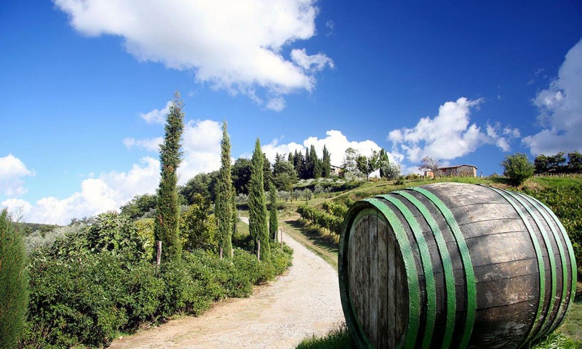 a barrel sitting on the side of a dirt road