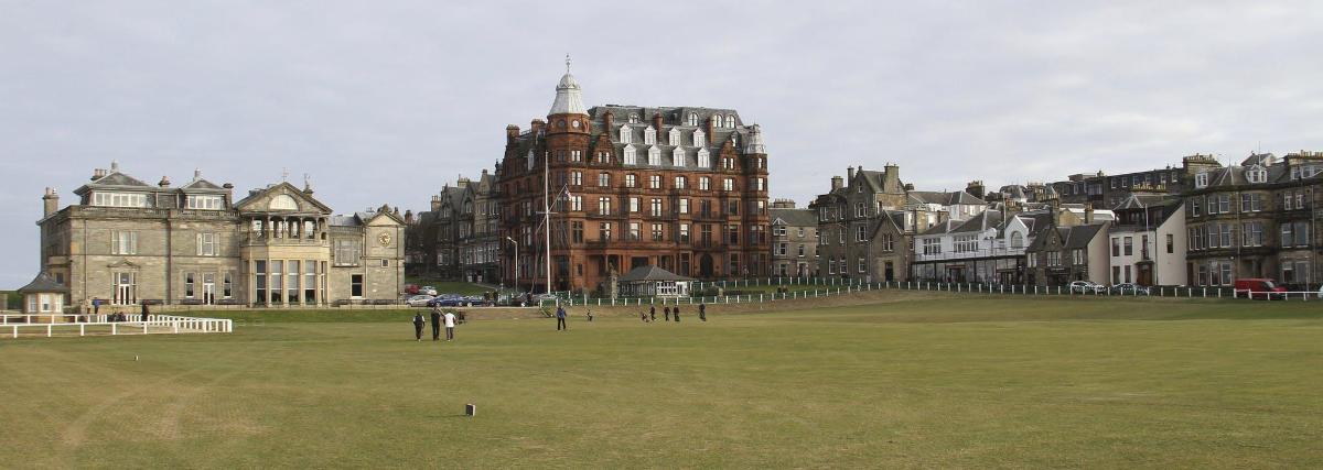 a large building in the middle of a grass field