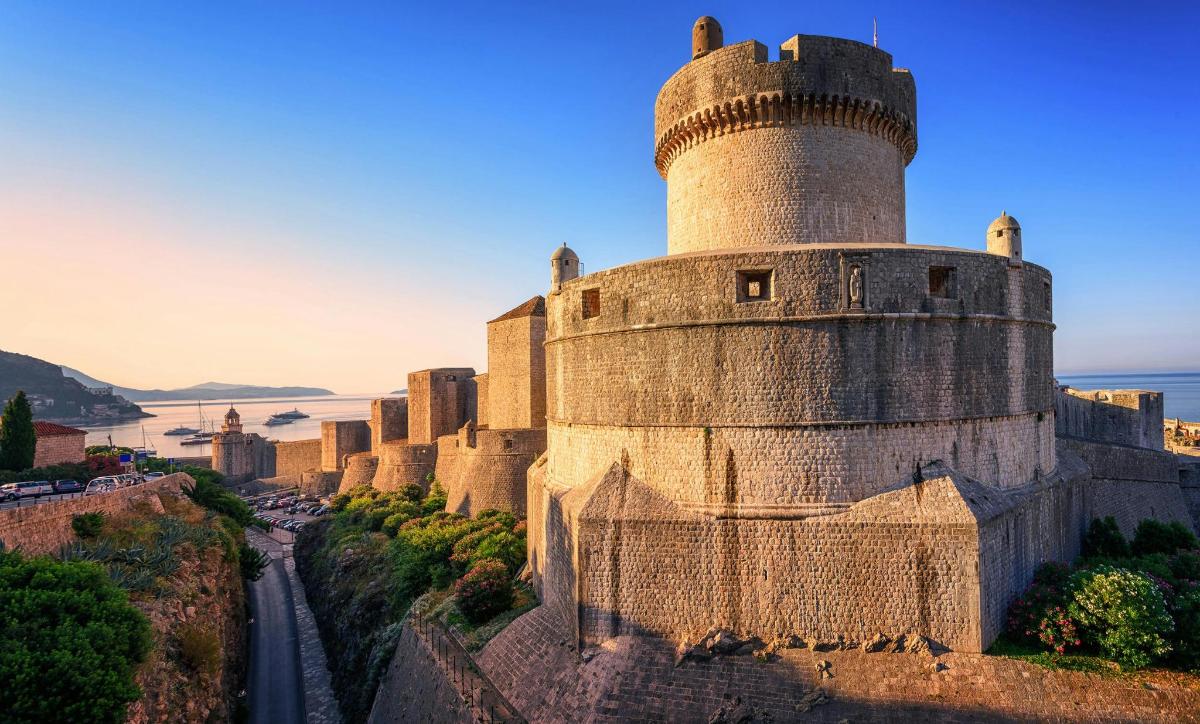an old castle with a tower on a hill