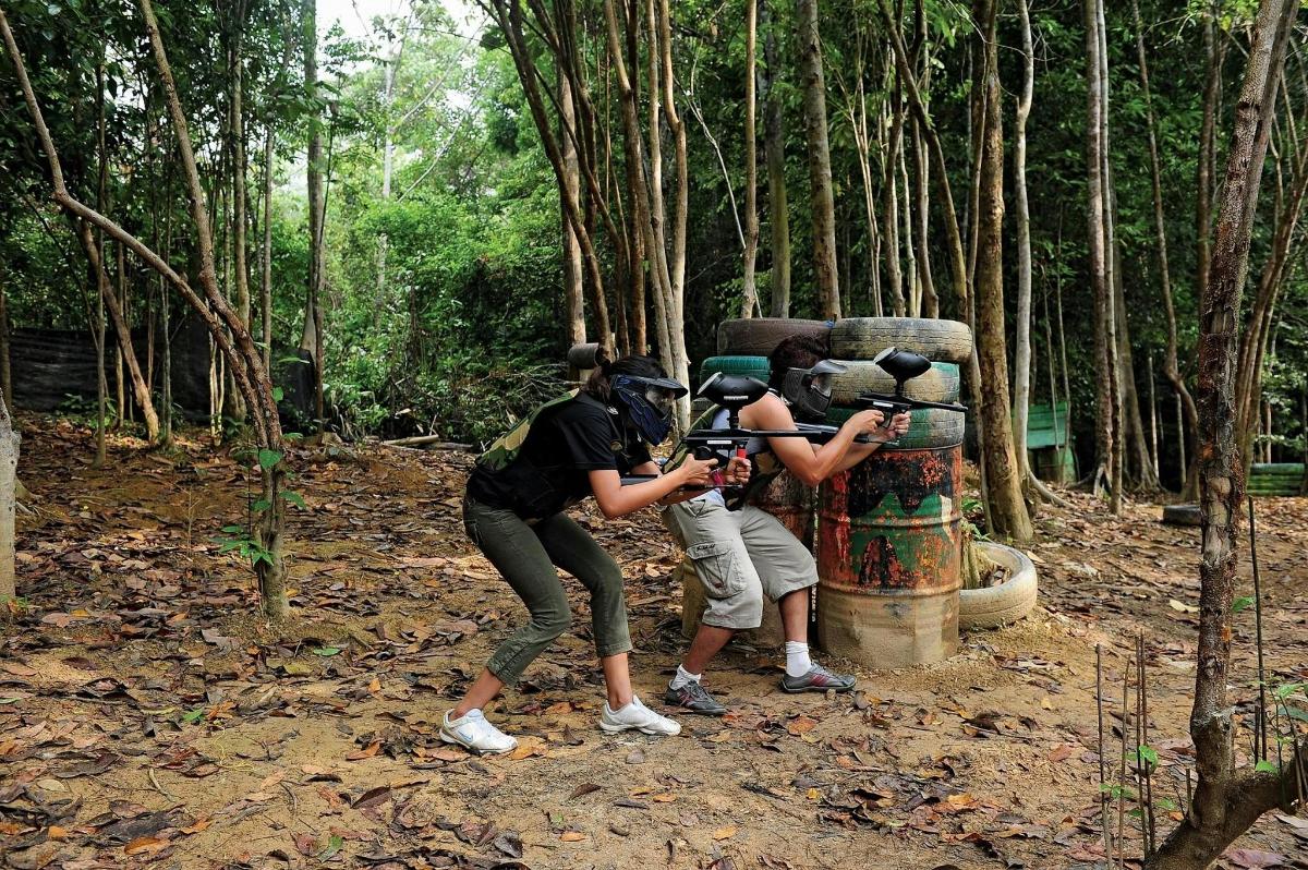 a group of people taking pictures of a statue in the forest
