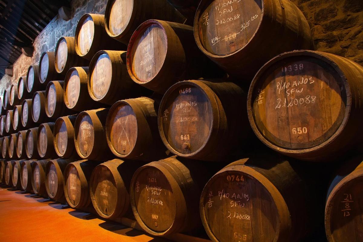 a stack of wine barrels in a cellar