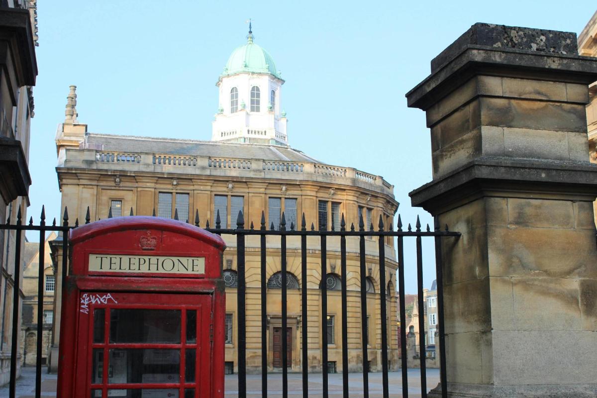 a red telephone booth in front of a building