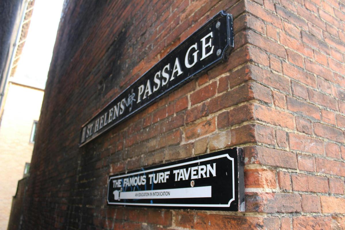 a brick wall with two signs on a building
