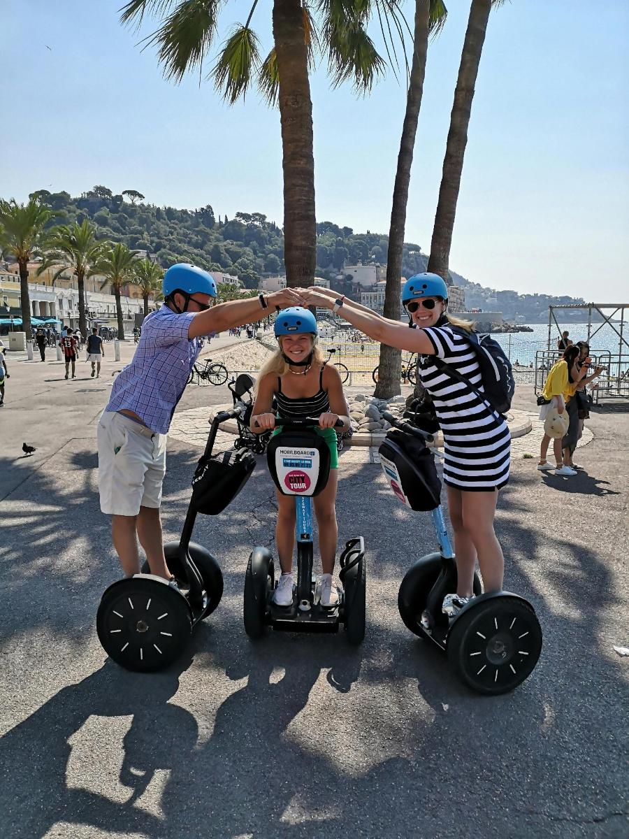 a group of three people riding segifts on the beach