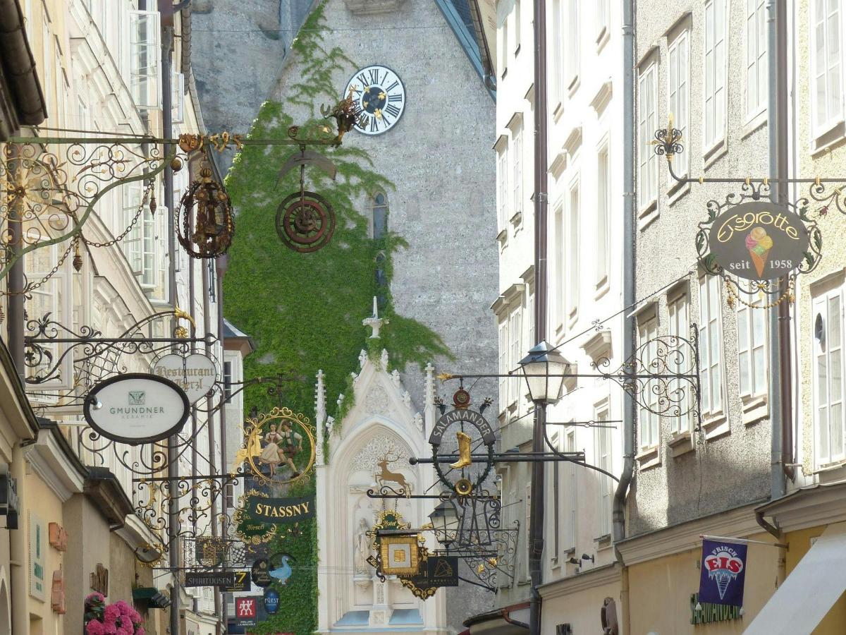 a street with a clock on the side of a building