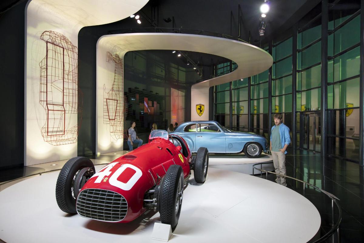 a red race car on display in a museum