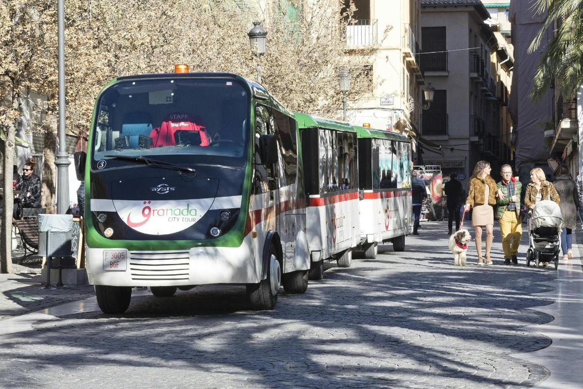 a green and white bus driving down a city street