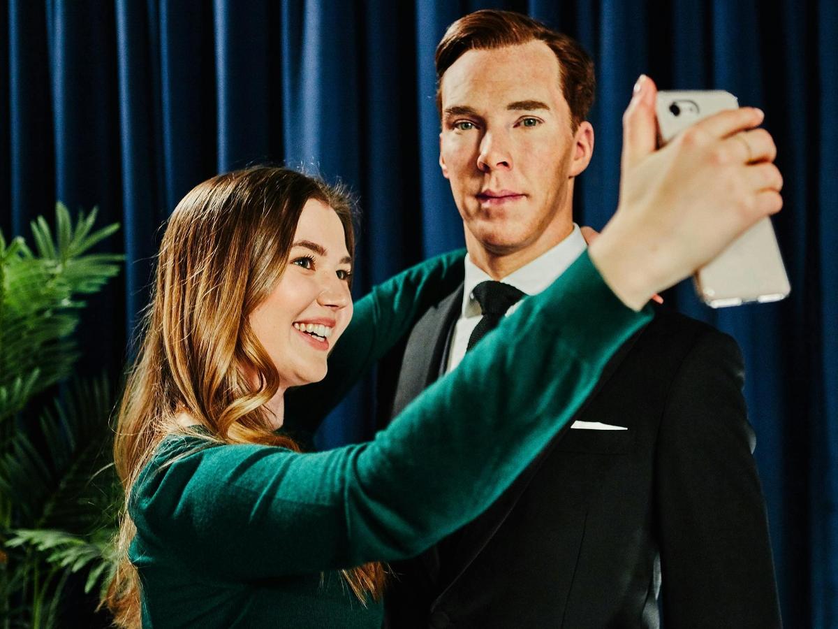 a woman taking a picture of a man taking a picture