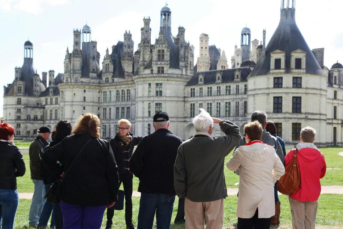 a group of people standing in front of a castle