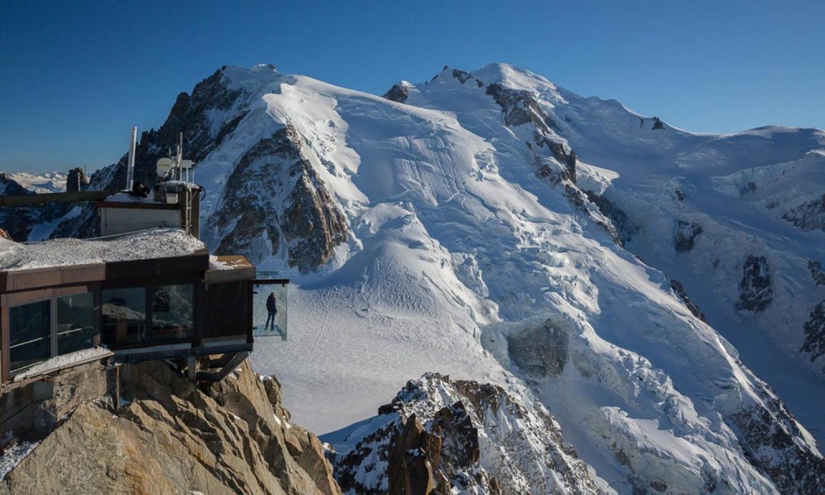 a snow covered mountain with a ski lift