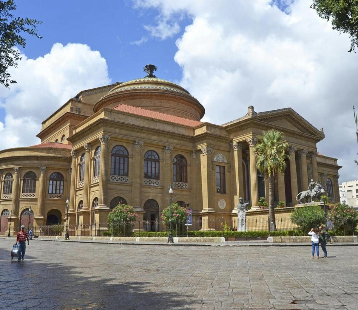 a large building with people standing in front of it
