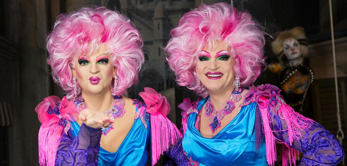 two women with pink hair standing next to each other