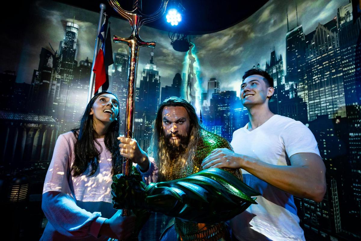 a group of three people standing in front of a city