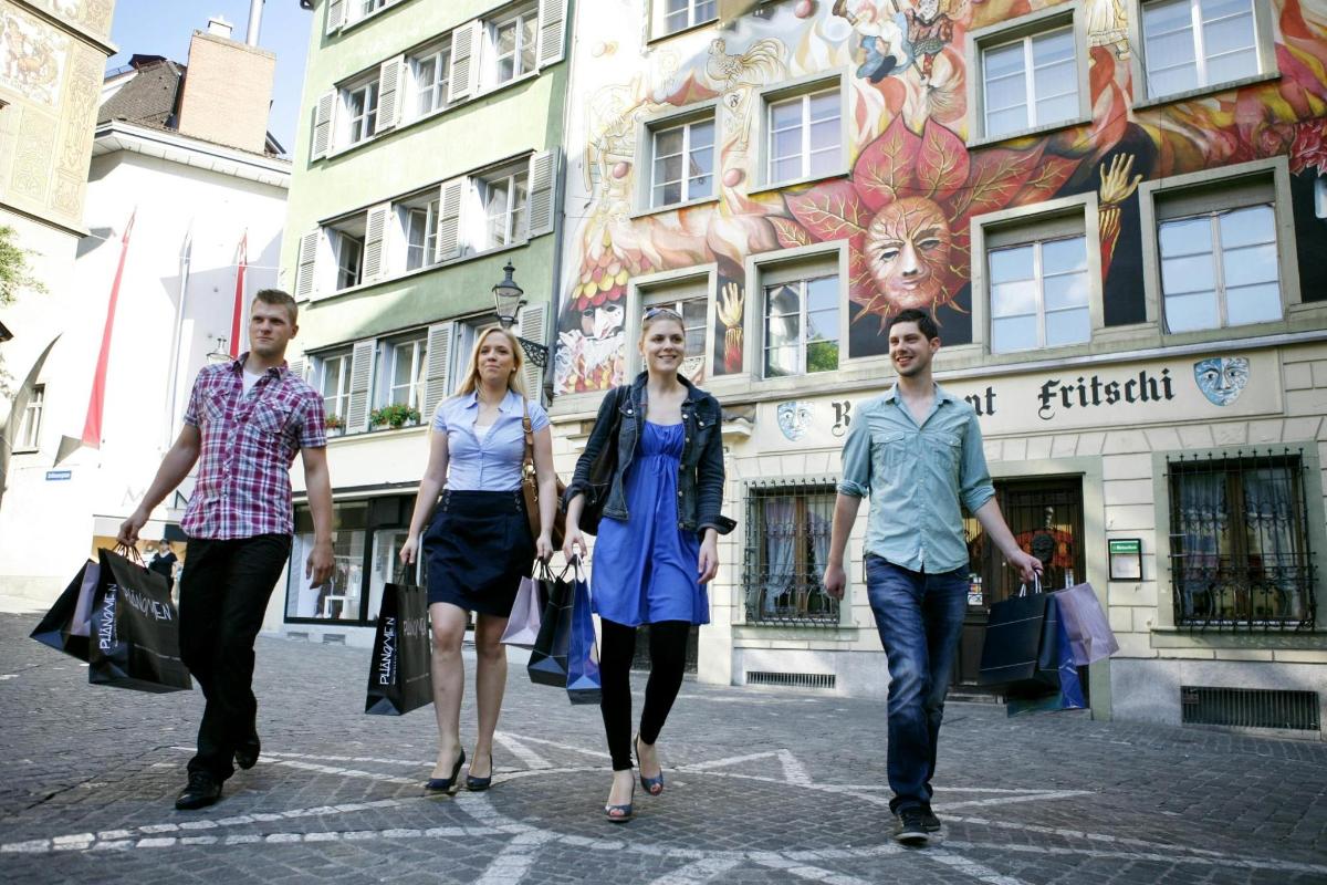a group of people walking down a street