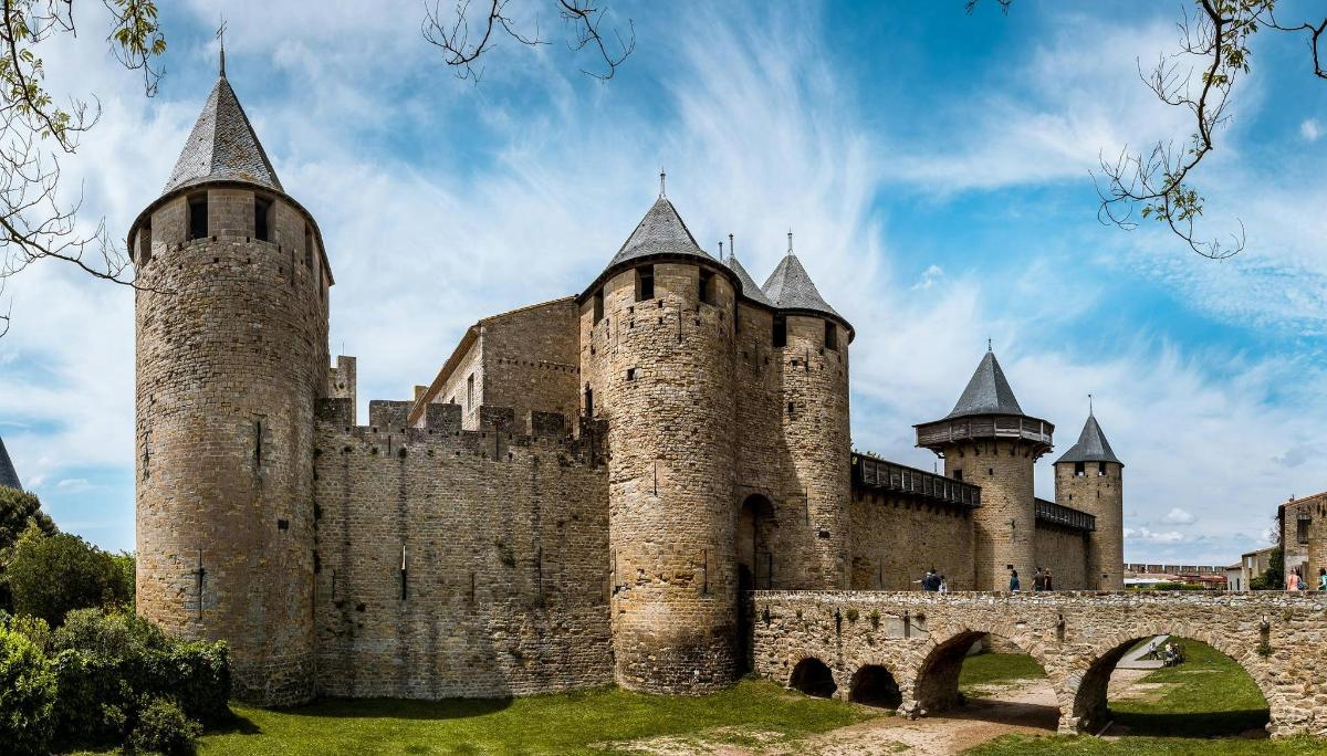 an old castle with two towers and a bridge