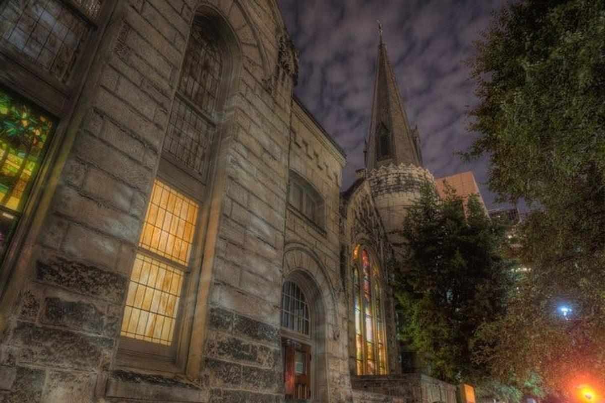 un edificio con una chiesa con un campanile di notte