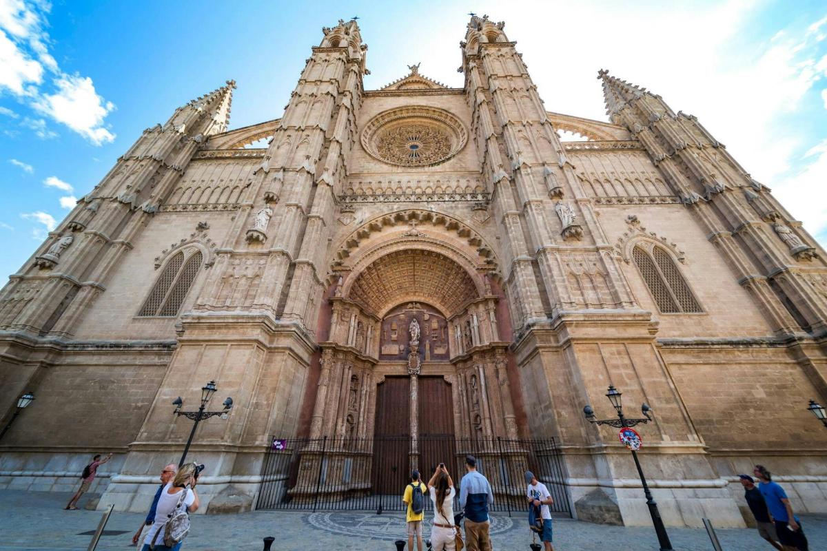a group of people standing in front of a cathedral