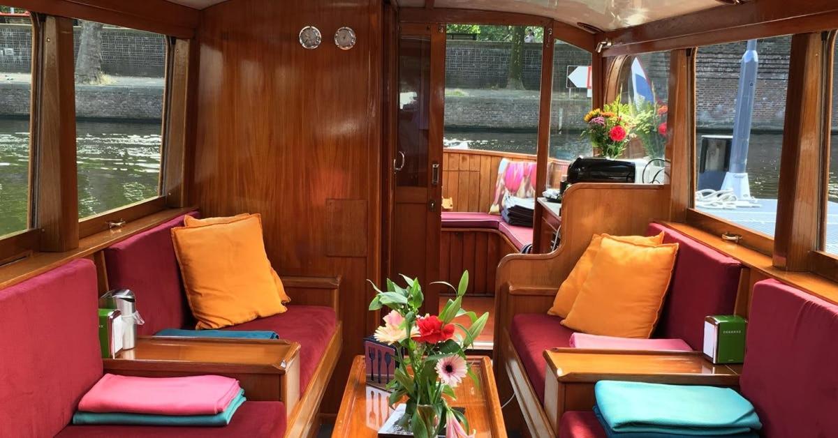 a boat with purple and orange cushioned seats on a boat