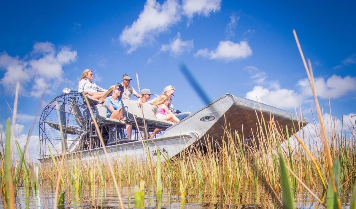 a group of people sitting on a boat in the water
