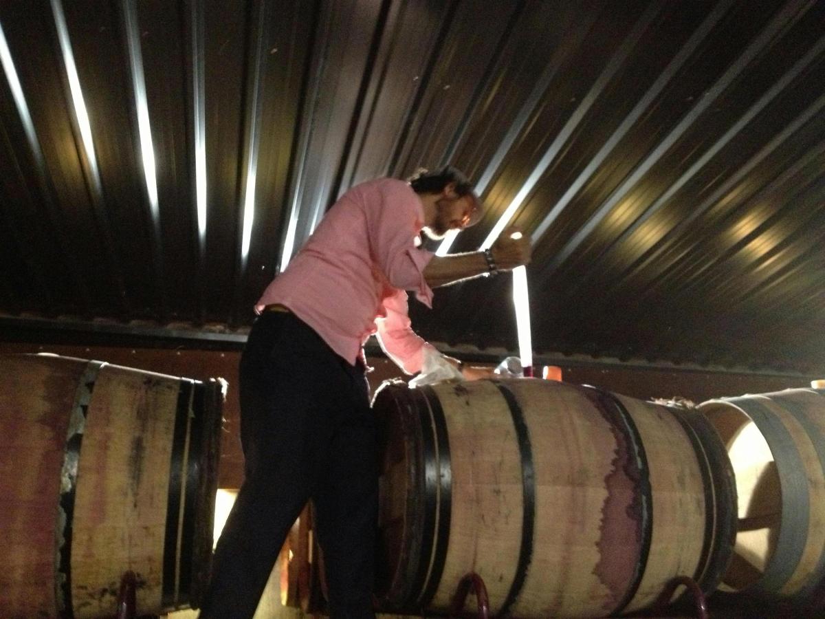 a man is standing on top of a barrel