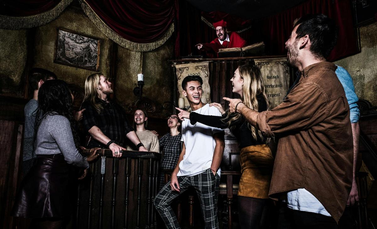 a group of people standing in a bar