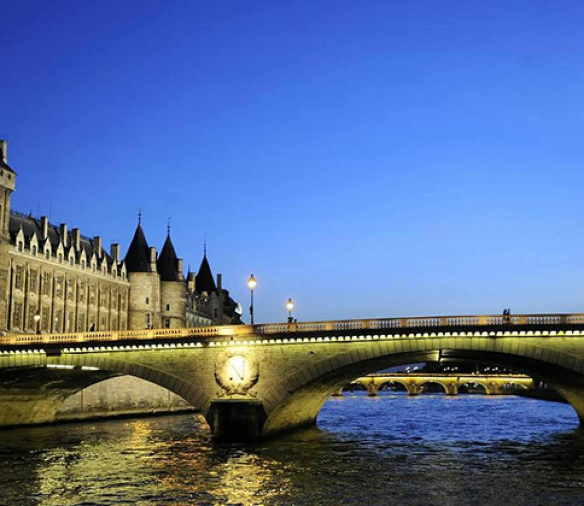a bridge over a river in front of a castle