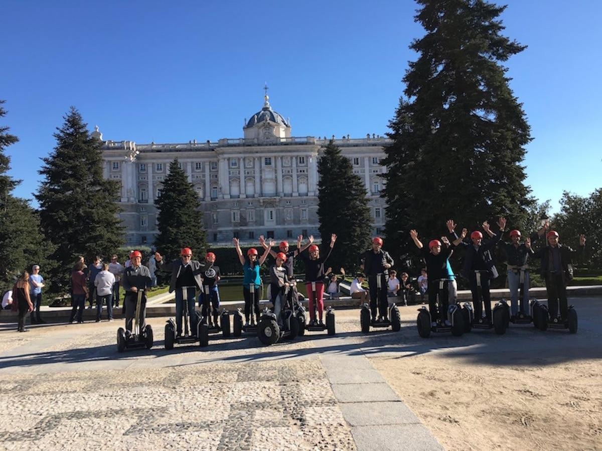 a group of people on segways in front of a building