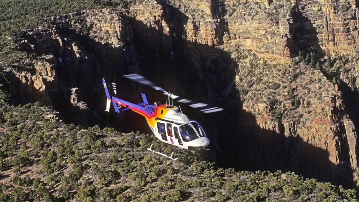 a helicopter is flying over a mountain