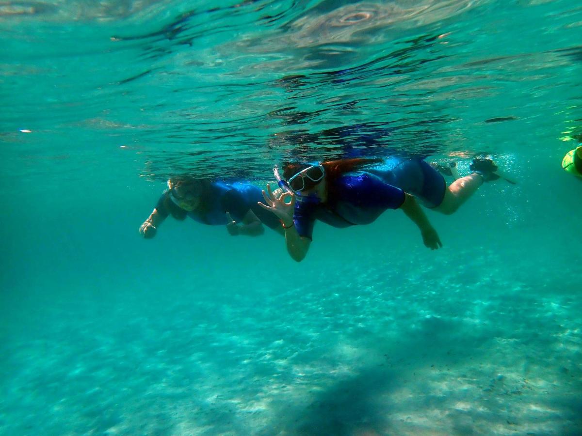 two people swimming in the water in the ocean