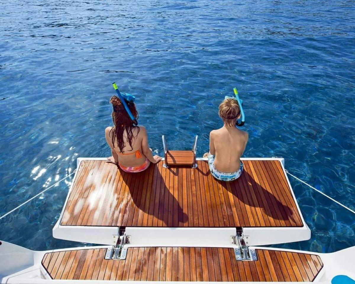 two people sitting on a boat in the water