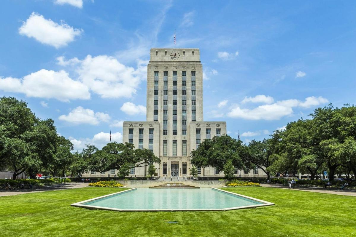 a building with a pool in the middle of a park
