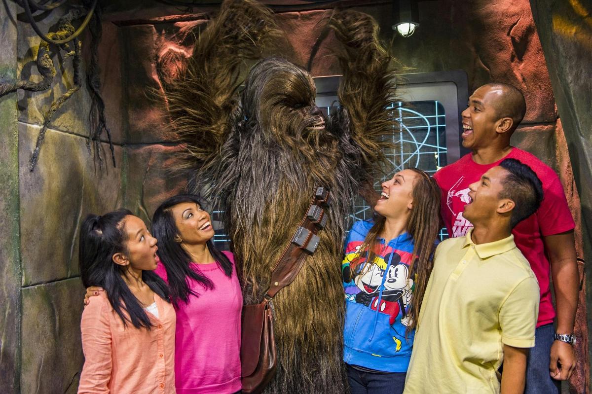 a group of people standing in front of a statue of a gorilla