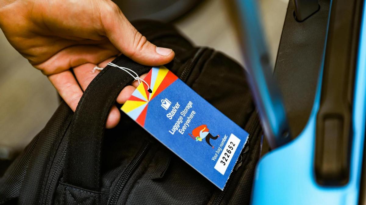 a person holding a tag on a bag