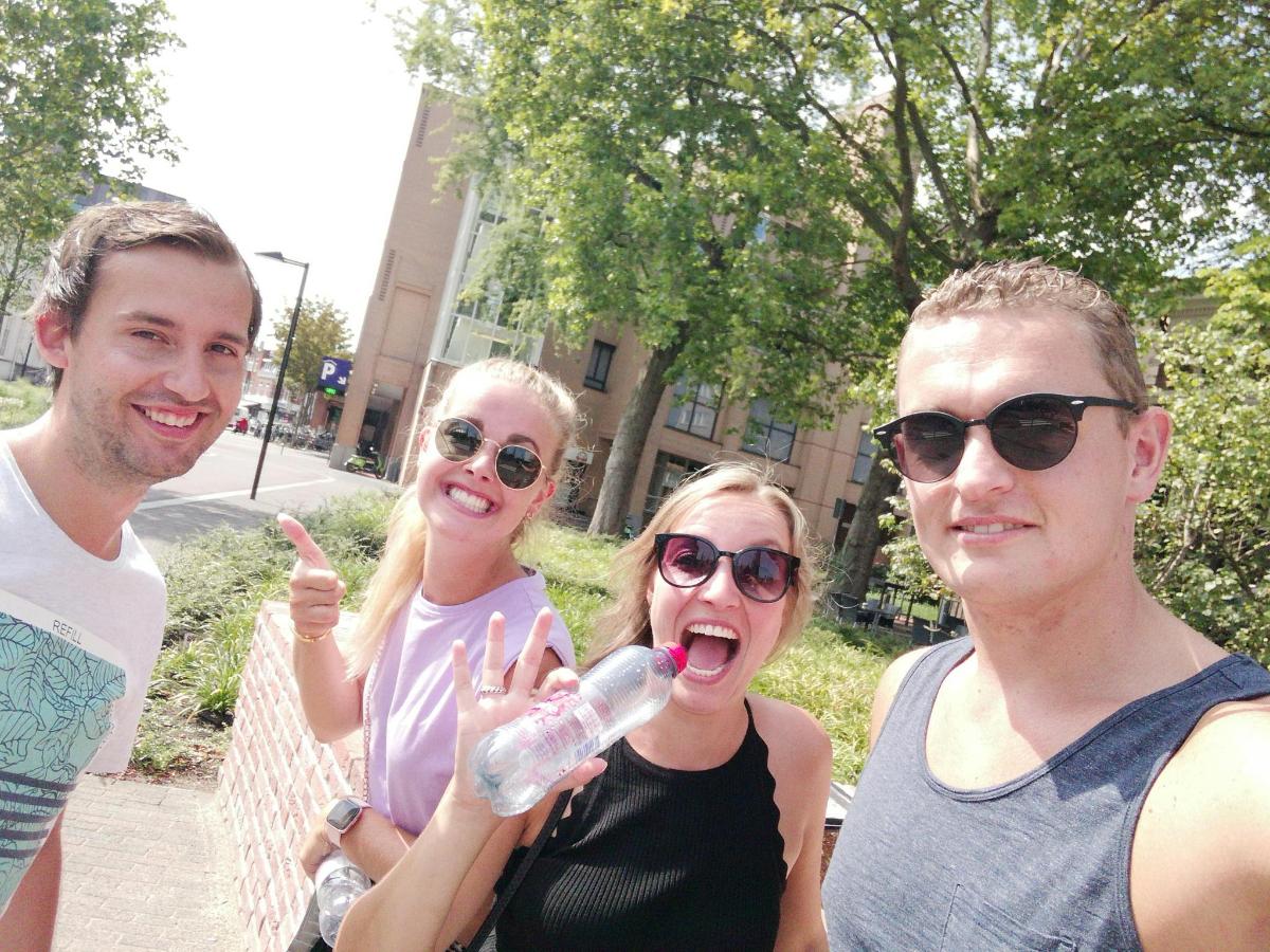 a group of people standing together with a water bottle