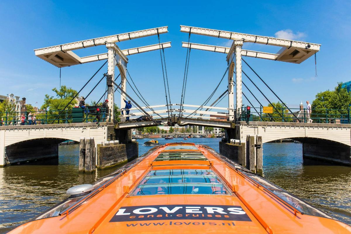 a boat in the water under a bridge
