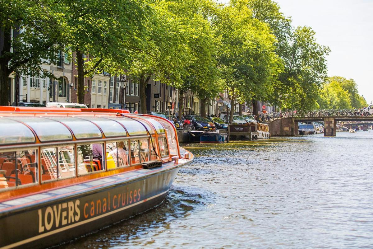 a boat traveling down a river in a city