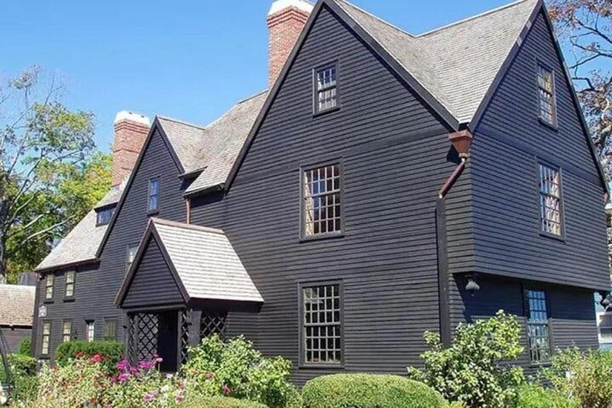 a large black house with a gray roof