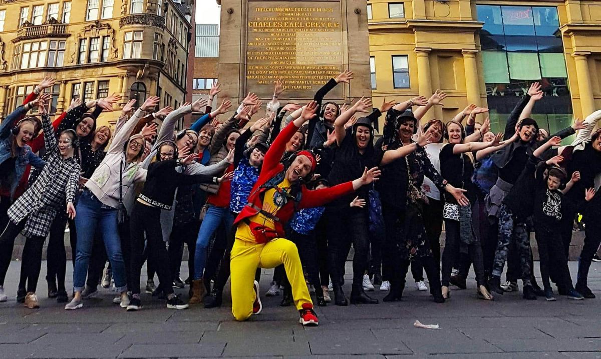 a group of people standing around a man in a crowd