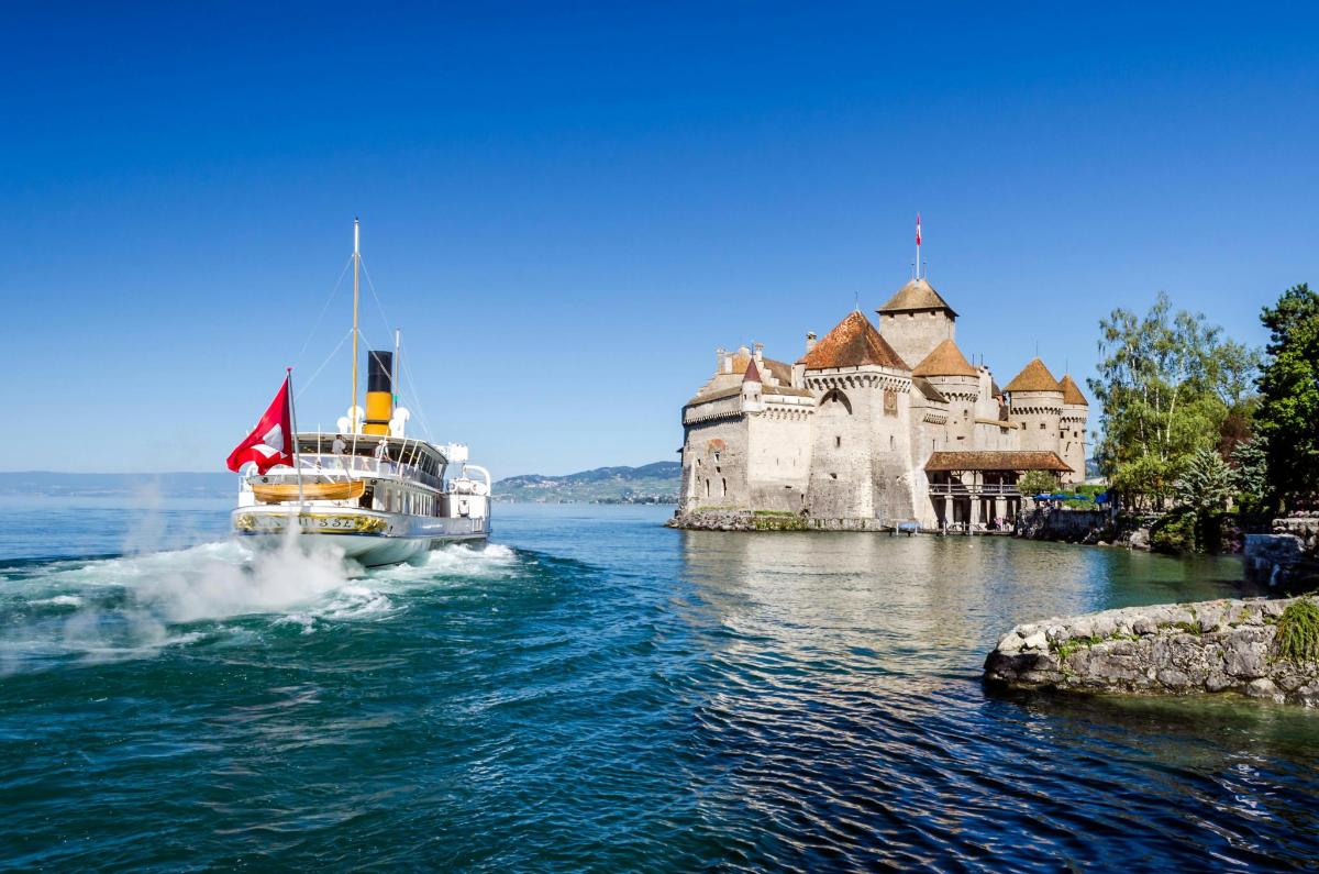 a boat in the water in front of a castle