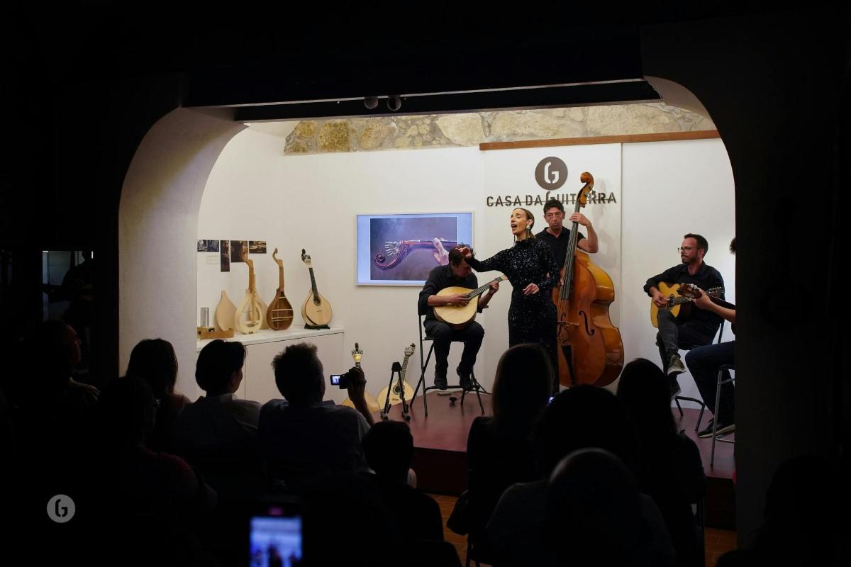 a group of people standing in a room with guitars