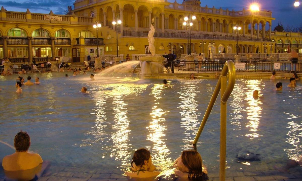 a group of people sitting in a fountain in a building