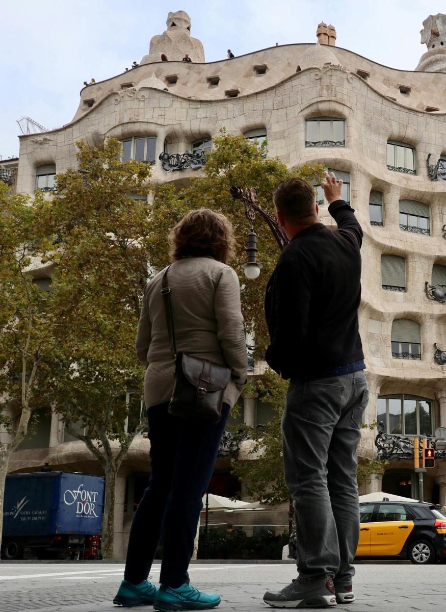 two people standing in front of a building