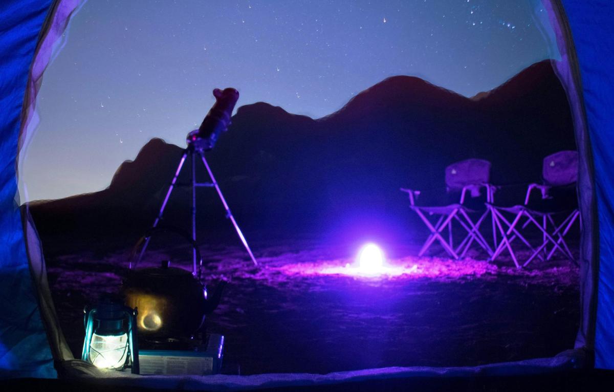 a view of a camera and a telescope at night