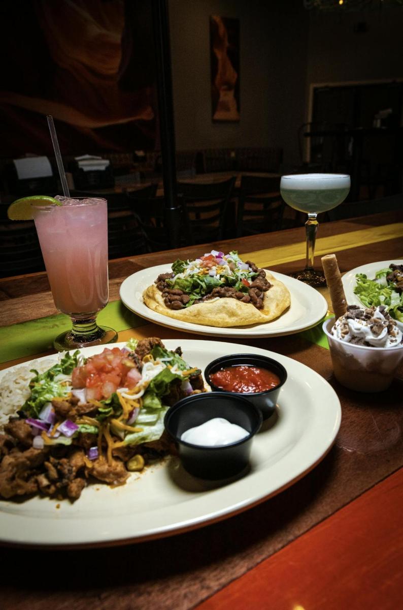 a table with two plates of food and a drink
