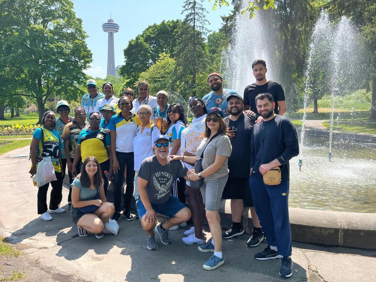 a group of people posing in front of a fountain