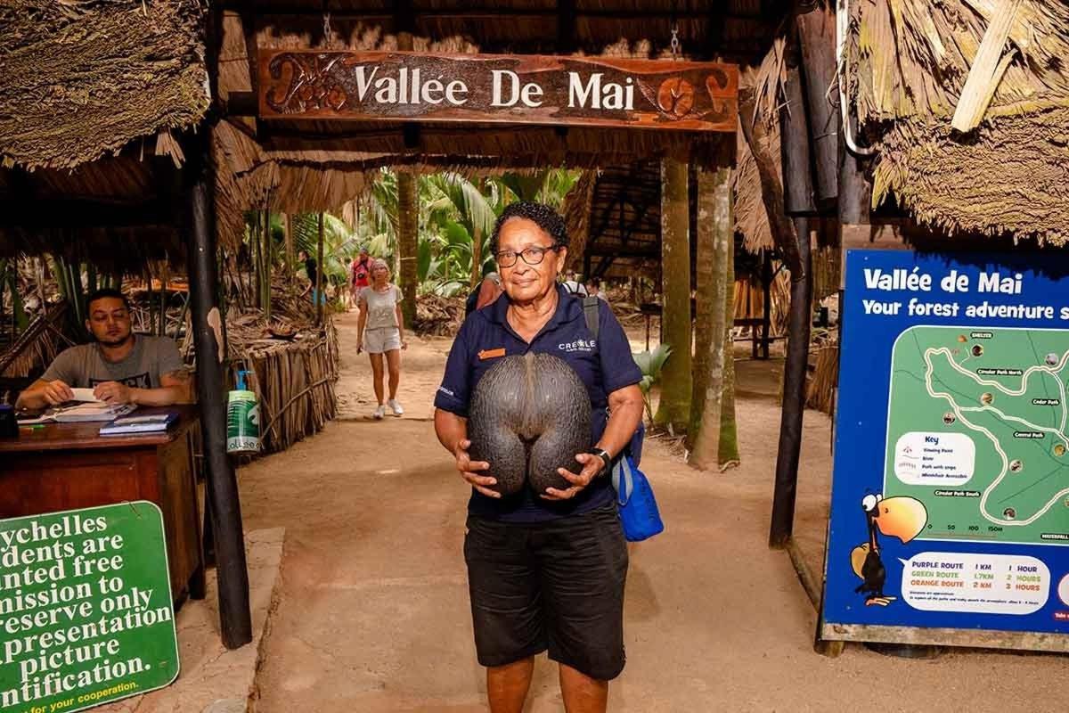 a man standing in front of a sign with a ball