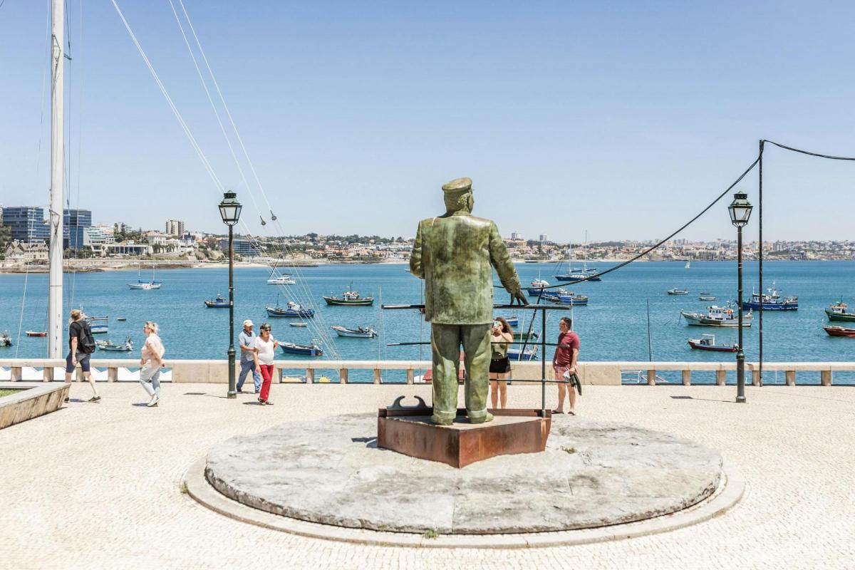 a statue of a man standing next to the water