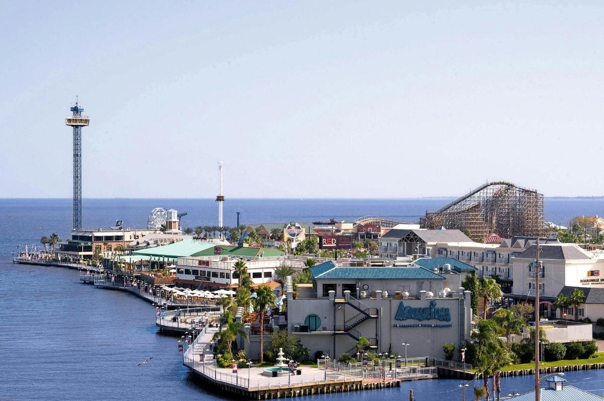 a city with a marina and a roller coaster